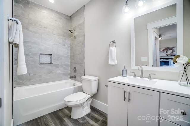 full bathroom with vanity, toilet, tiled shower / bath combo, and wood-type flooring