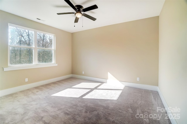 unfurnished room featuring light carpet and ceiling fan