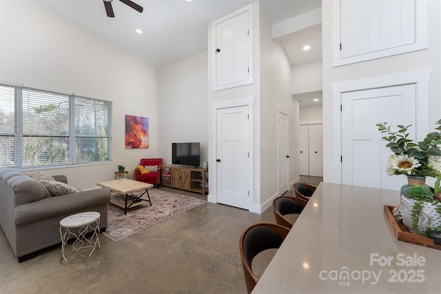 living room featuring high vaulted ceiling and ceiling fan