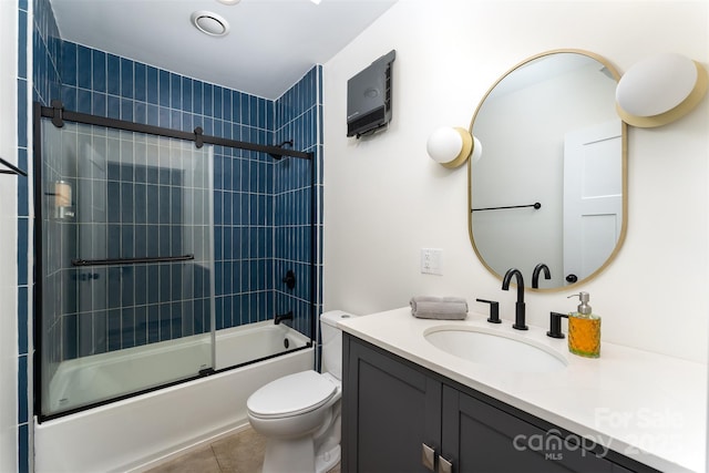 full bathroom featuring tile patterned flooring, vanity, toilet, and enclosed tub / shower combo