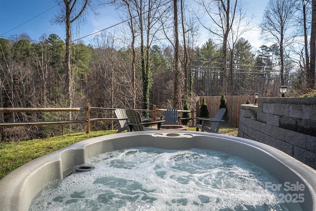 view of swimming pool featuring a hot tub