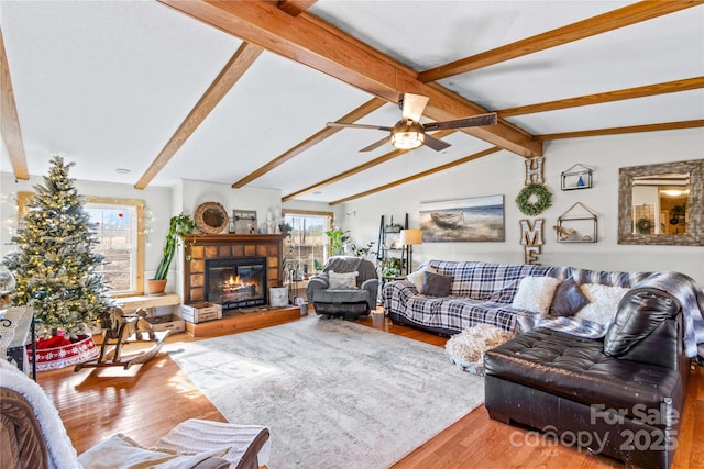 living room featuring vaulted ceiling with beams, hardwood / wood-style floors, and ceiling fan