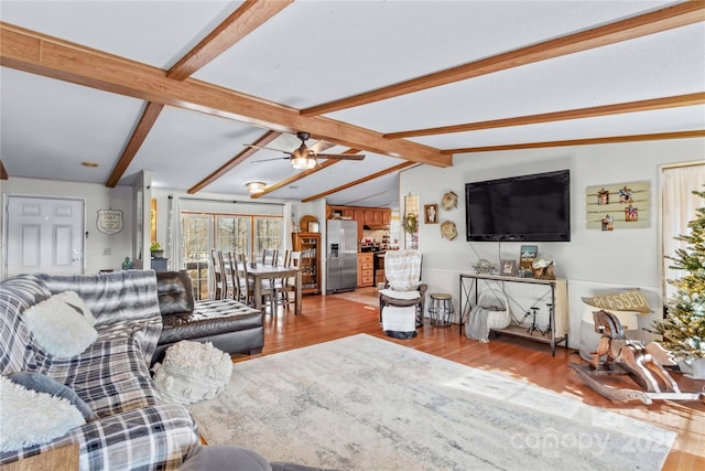 living room featuring vaulted ceiling with beams, light hardwood / wood-style floors, and ceiling fan