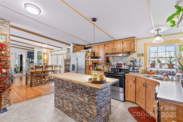 kitchen with pendant lighting, sink, a center island, stainless steel appliances, and a textured ceiling