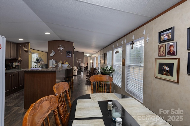 dining area with lofted ceiling and dark wood-type flooring