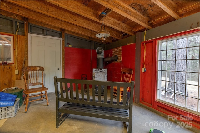 bedroom with a wood stove and concrete floors