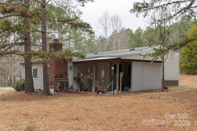 back of property featuring a yard