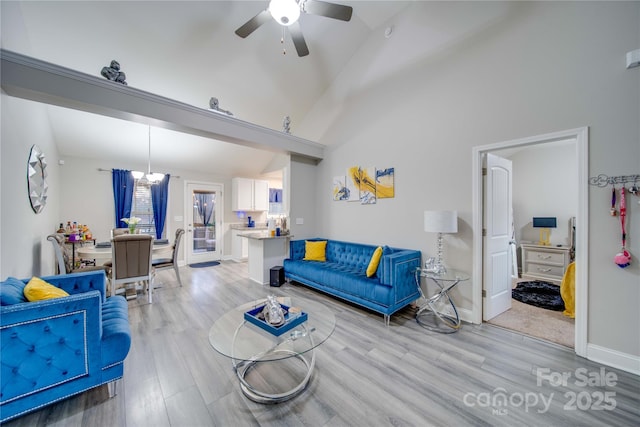 living room featuring ceiling fan, high vaulted ceiling, and light hardwood / wood-style flooring