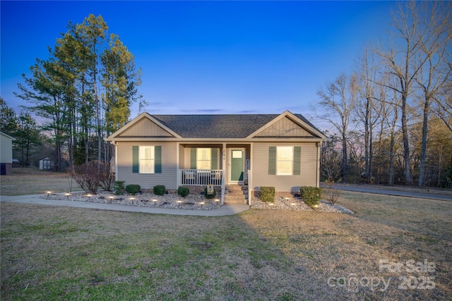 single story home with a yard and covered porch