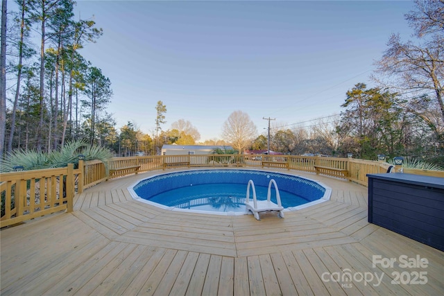 view of swimming pool featuring a wooden deck