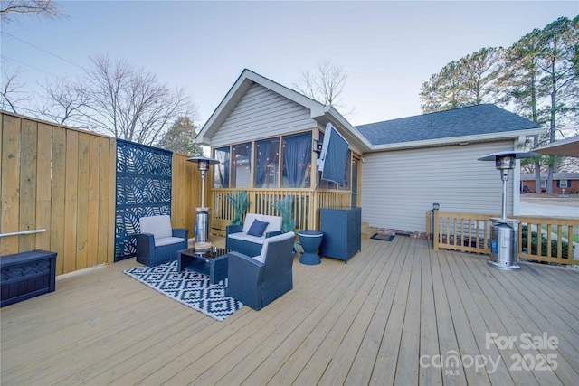 wooden deck with an outdoor living space and a sunroom