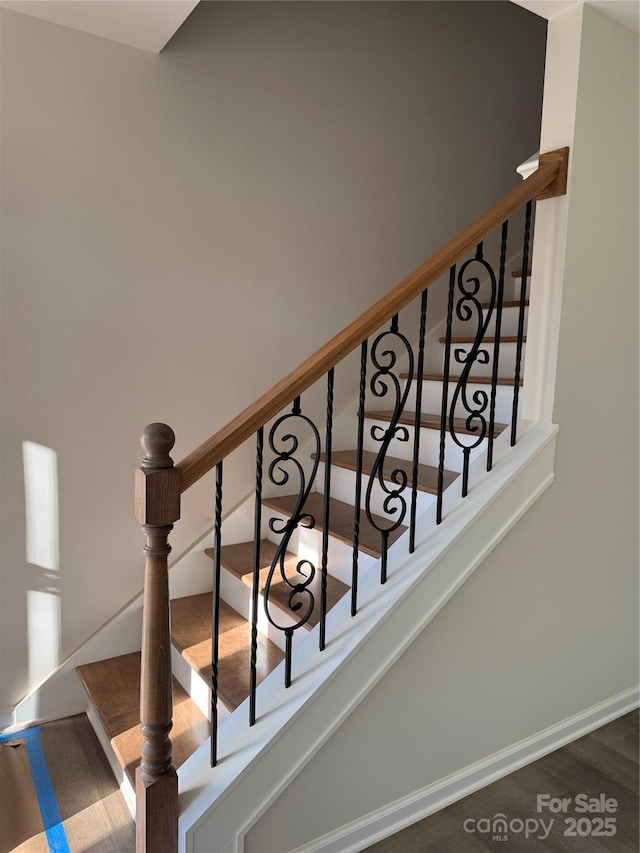 staircase featuring baseboards