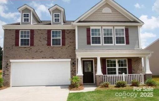 view of front of house with a garage, covered porch, and a front lawn