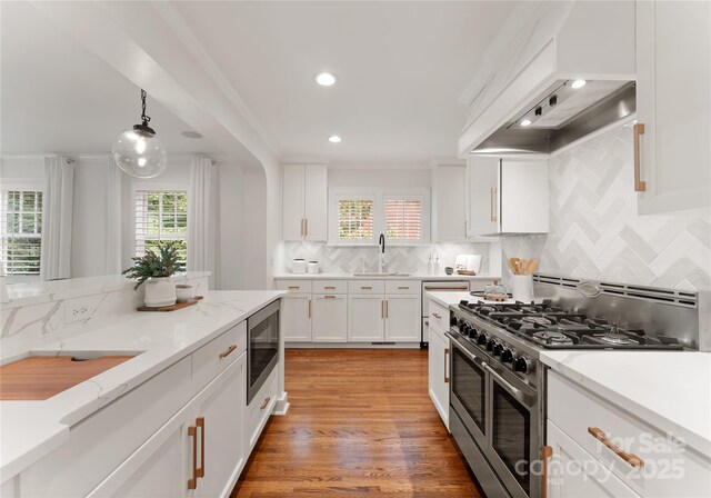 2809 Glendale Rd, Charlotte, NC 28209 - kitchen with appliances with stainless steel finishes, a sink, plenty of natural light, white cabinets, and recessed lighting