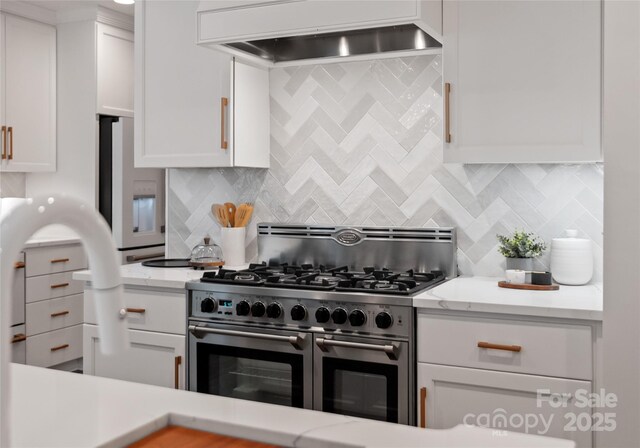 2809 Glendale Rd, Charlotte, NC 28209 - kitchen featuring double oven range, custom exhaust hood, white cabinets, decorative backsplash, and light stone countertops
