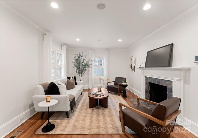 2809 Glendale Rd, Charlotte, NC 28209 - living room with a fireplace, wood finished floors, recessed lighting, baseboards, and crown molding