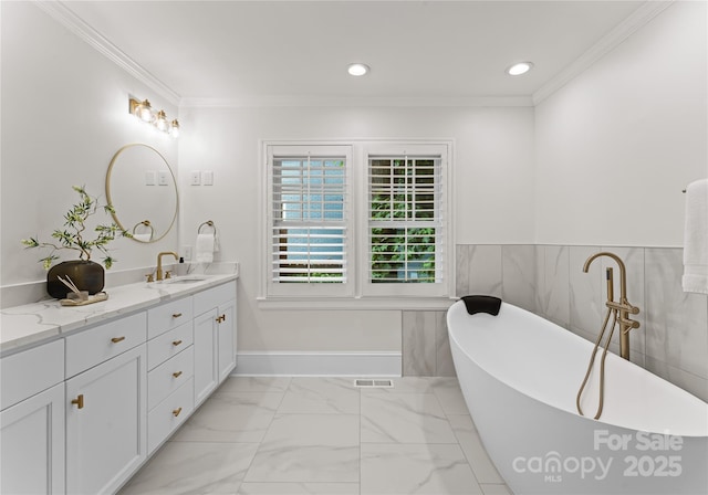 2809 Glendale Rd, Charlotte, NC 28209 - bathroom featuring double vanity, a freestanding tub, crown molding, recessed lighting, and marble finish flooring