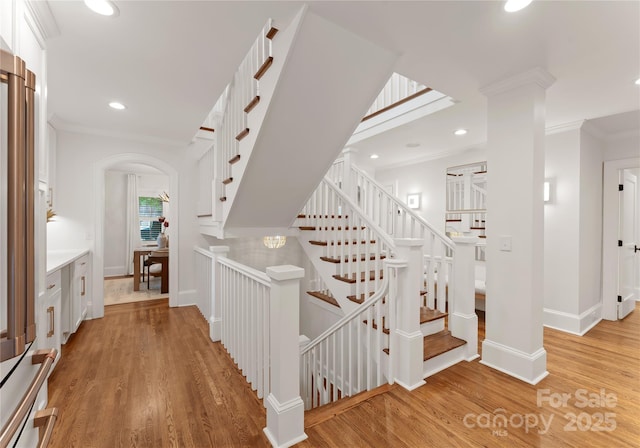 2809 Glendale Rd, Charlotte, NC 28209 - stairs featuring wood finished floors, baseboards, recessed lighting, arched walkways, and crown molding