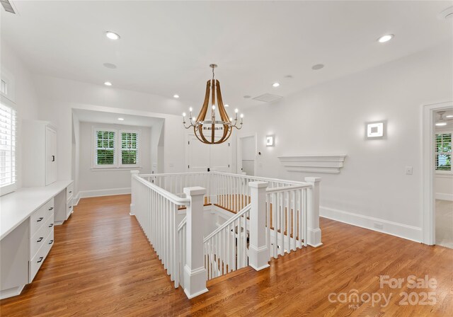 2809 Glendale Rd, Charlotte, NC 28209 - corridor with an upstairs landing, plenty of natural light, light wood finished floors, and recessed lighting