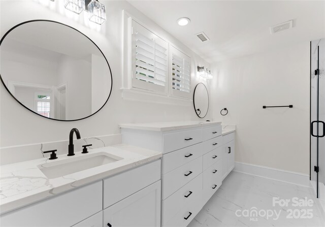 2809 Glendale Rd, Charlotte, NC 28209 - bathroom featuring vanity, marble look tiles, baseboards, recessed lighting, and a stall shower