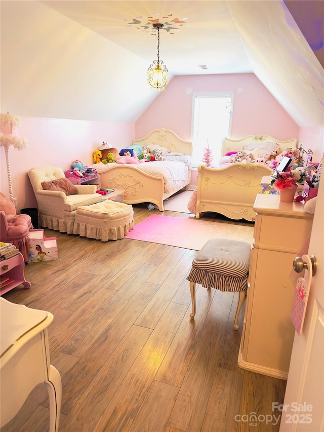 bedroom featuring vaulted ceiling and hardwood / wood-style floors