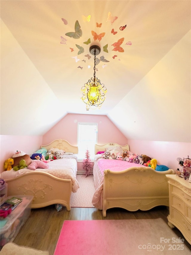 bedroom with wood-type flooring and vaulted ceiling