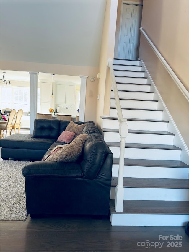 living room featuring decorative columns and dark hardwood / wood-style flooring