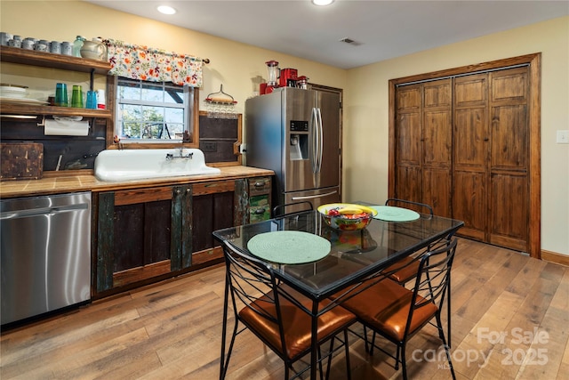 kitchen featuring light hardwood / wood-style floors and appliances with stainless steel finishes