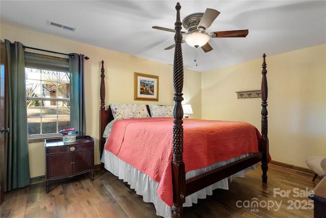 bedroom with dark hardwood / wood-style flooring and ceiling fan