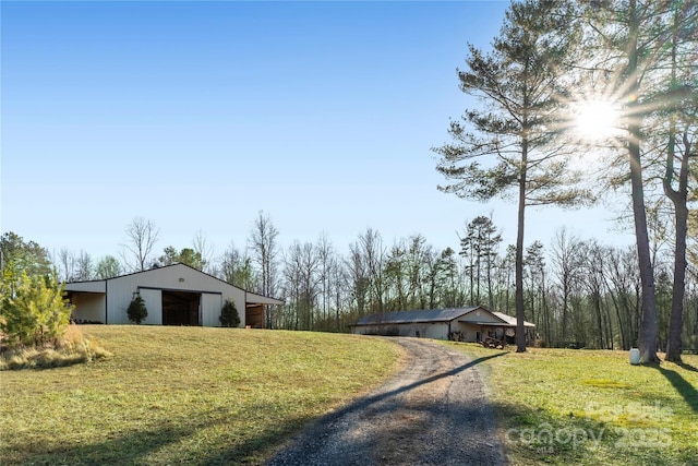 view of yard featuring a garage and an outdoor structure