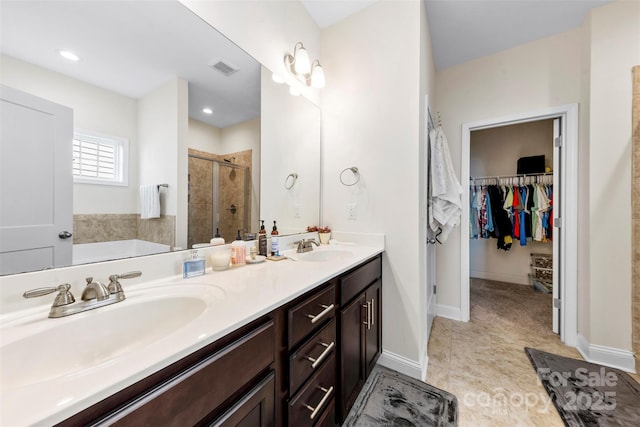 bathroom featuring walk in shower and vanity