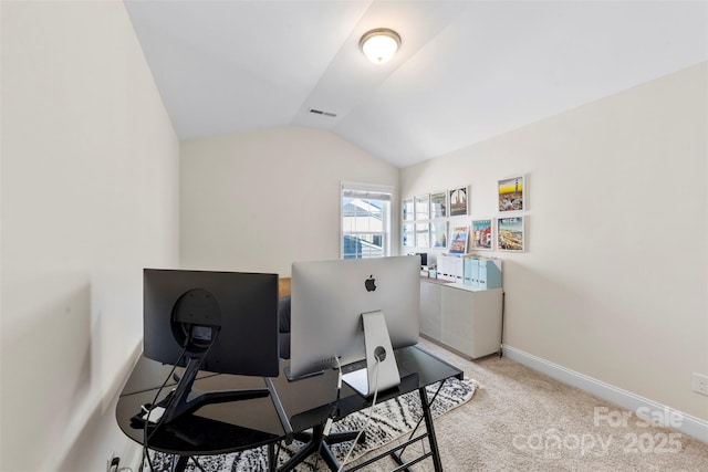 carpeted home office featuring lofted ceiling