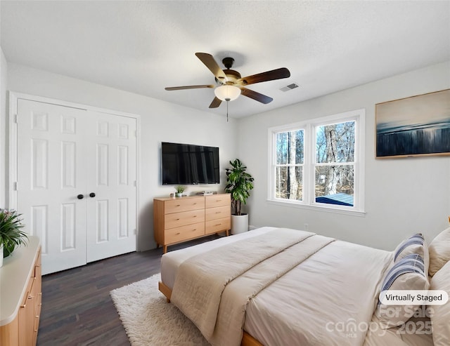 bedroom featuring dark hardwood / wood-style flooring, a closet, and ceiling fan