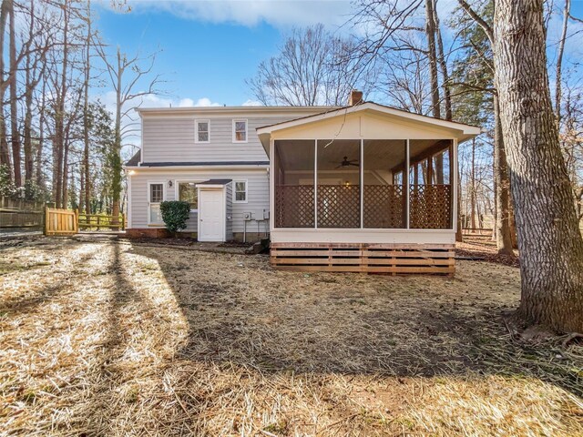 back of house with ceiling fan and a sunroom