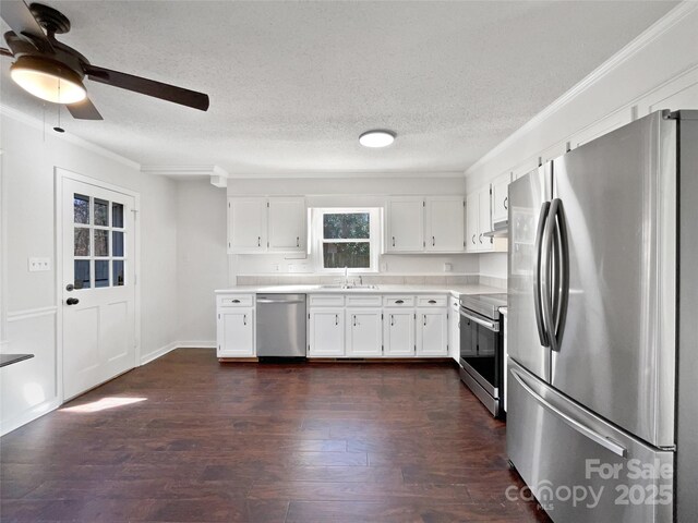 kitchen with white cabinetry, crown molding, a textured ceiling, dark hardwood / wood-style floors, and stainless steel appliances