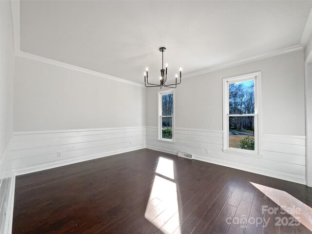 unfurnished dining area with crown molding, plenty of natural light, and dark wood-type flooring