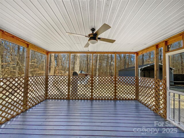 wooden deck featuring ceiling fan