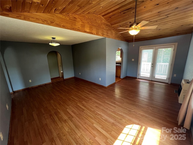 empty room featuring hardwood / wood-style flooring, lofted ceiling, wooden ceiling, and french doors