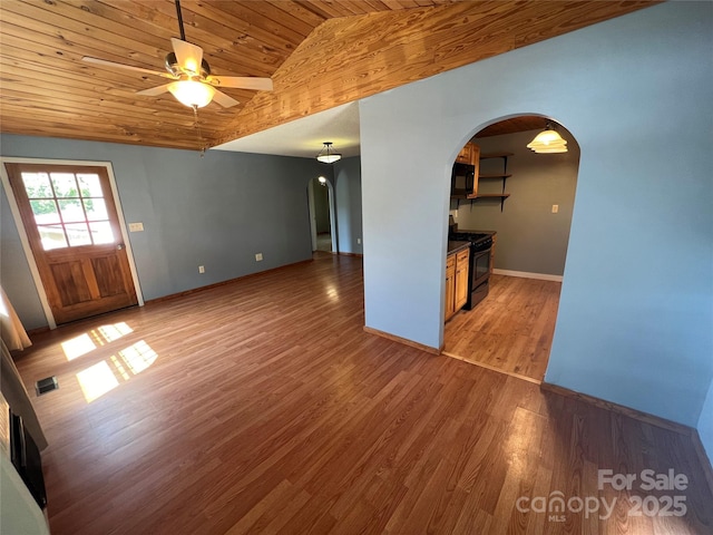 unfurnished living room with lofted ceiling, wooden ceiling, dark hardwood / wood-style floors, and ceiling fan