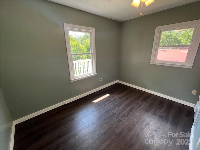 unfurnished room with dark hardwood / wood-style flooring