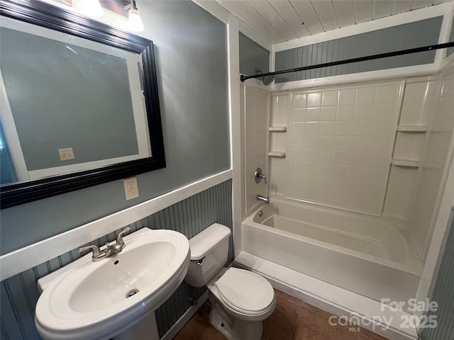 full bathroom with toilet, sink, and  shower combination