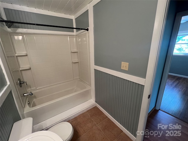 bathroom with washtub / shower combination and toilet