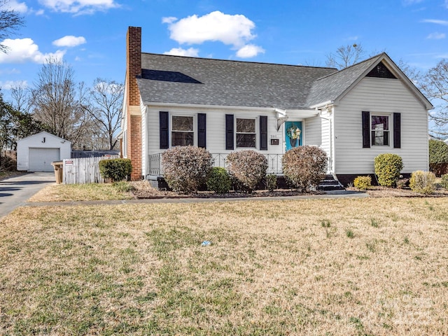 ranch-style home featuring an outbuilding, a garage, and a front lawn