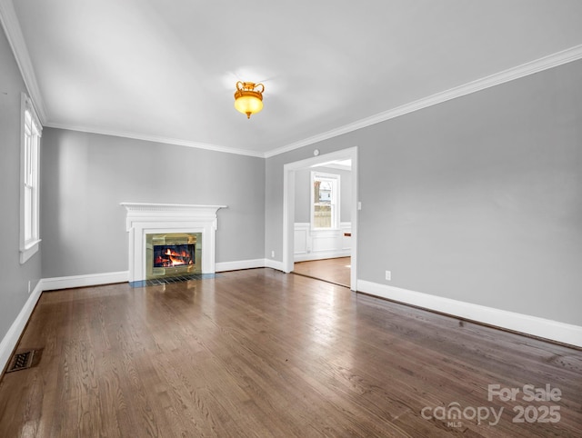 unfurnished living room featuring a premium fireplace, dark wood-type flooring, and ornamental molding