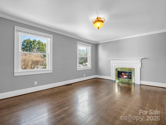 unfurnished living room featuring dark hardwood / wood-style flooring and ornamental molding