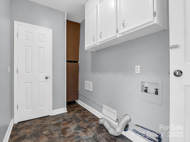 laundry area featuring washer hookup and cabinets