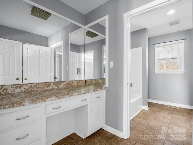 bathroom featuring vanity, tile patterned floors, and shower / bath combination