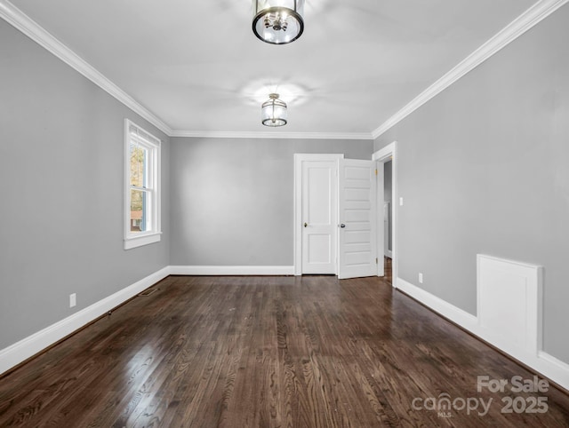 unfurnished room with dark wood-type flooring and ornamental molding