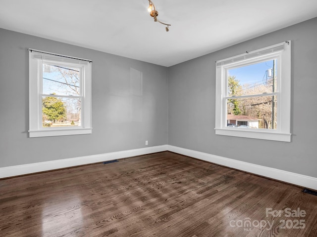 spare room featuring wood-type flooring