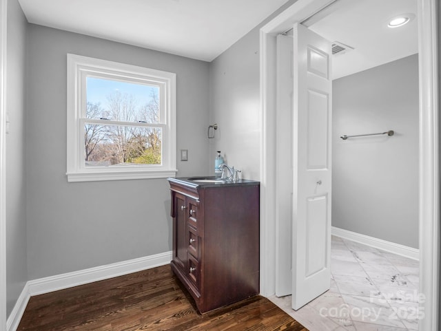 bathroom featuring vanity and wood-type flooring